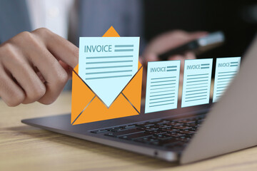 E-invoice and online digital statements concept, digital electronic bill and invoice account. Businessman using computer laptop with invoice documents icon on virtual screen.