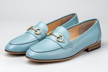 Naklejka premium Light Blue Leather Loafers with Gold Buckle – Minimalist Shoe Display on Grey Background