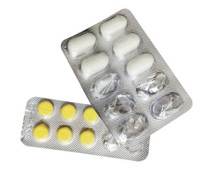 An elevated, slightly angled view of two overlapping pharmaceutical blister packs. One pack...