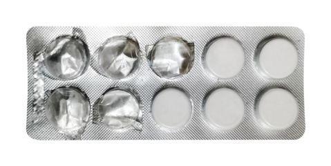 A direct overhead shot of a blister pack, prominently displaying four white, round pills on one side and six empty, pressed-out compartments on the other. The clear distinction between full and empty 