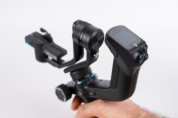 Handheld gimbal stabilizer in use for smooth video recording during a creative project in a studio environment