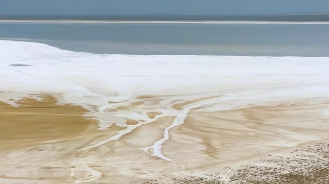 Lake Tuzbair in Kazakhstan. A salt lake near the Tuzbair mountains. Sor-Tuzbair is one of the wonders of Mangystau nature. Chalk hills and limestone cliffs. A salt marsh near the great Ustyurt plateau