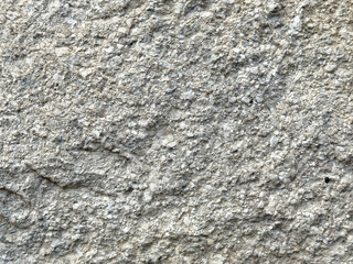 Detailed rough gray stone texture with fine cracks and pebble patterns