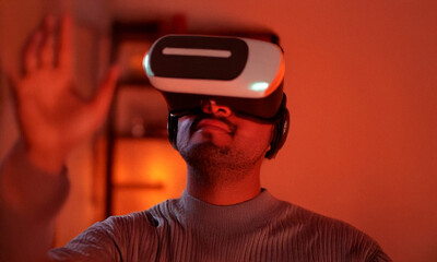 Man using VR headset in modern living room, neutral background
