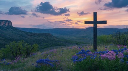 Sunset landscape with a wooden cross amidst blooming wildflowers in a serene valley