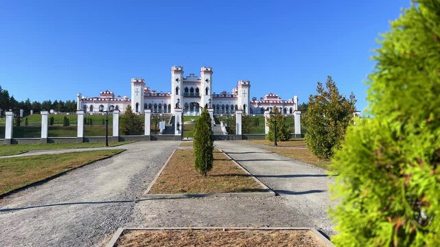 Belarus, Puslovsky Palace, September 5, 2024: Kossovsky Autumn Castle. An old historical castle in Kosovki in sunny autumn weather. An architectural monument in the style of English Neo-Gothic. 4K