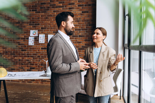 Architects discussing project details in modern office