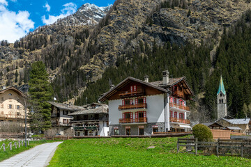 Village of Gressoney-Saint-Jean with traditional wooden and stone buildings and a amountain on background in the Aosta Valley, Italy