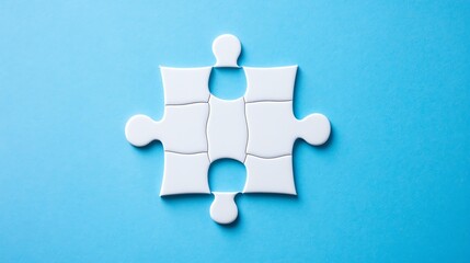 Obraz premium A single, glossy blue puzzle piece rests against a vibrant blue background.