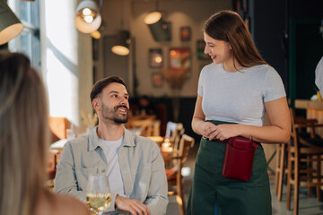 Waitress taking order from customer in restaurant
