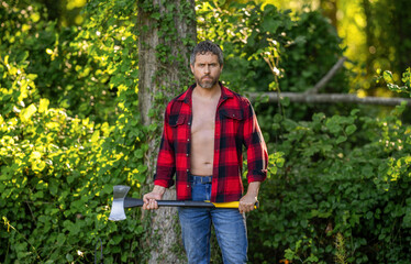 Hispanic lumberjack man with axe. Lumberjack axe. Man with logging axe. Brutal man in unbuttoned...