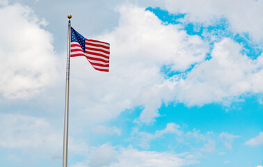 American flag waving for independence day. Flag of the USA. National waving flag of united states on blue sky. Independence day. Patriotic symbol. American Flag for Memorial Day or 4th of July