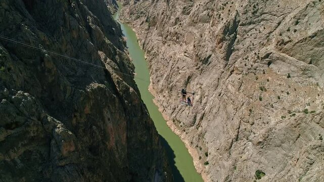 Person Jumping from Platform into Canyon Over River, Aerial Extreme Sports Scene