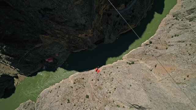 Extreme Jump from Canyon Platform into River with Parachute Deployment, Aerial View