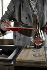 Champagne tasting, The sommelier pours sparkling wine from the decanter into a beautiful glass,...