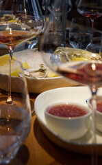 Champagne tasting, Wine glasses are on the table, stylish table setting, sparkling wine bubbles, oysters and sea urchins, special sauce