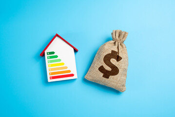 House with energy efficiency scale and dollar money bag. Saving budget money by saving energy....