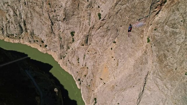 Person Jumping from Platform into Canyon Over River, Aerial Extreme Sports Scene