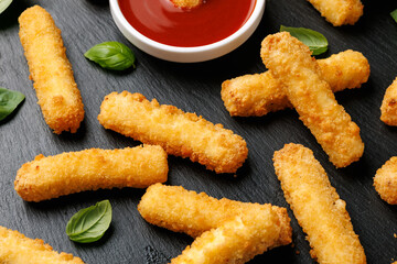 Crispy Halloumi cheese sticks with tomato sauce.
