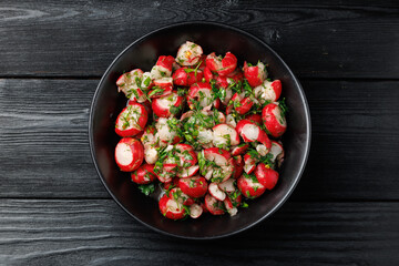 Smashed radish salad. Marinated radishes with vinegar, parsley, garlic, olive oil and dill. Healthy food