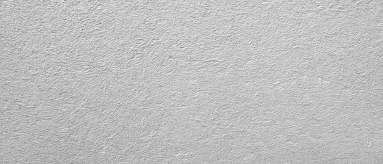 A white wall with a grey texture. The wall is very plain and has no decoration, abstract texture background for template pages and banners