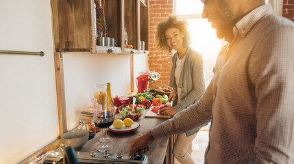 Everyday life of millennial couple. African-american man and woman preparing lunch in kitchen together, panorama, copy space