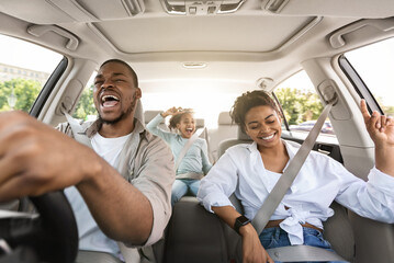 Joyful African American Family Riding New Car Singing And Having Fun During Summer Road Trip....