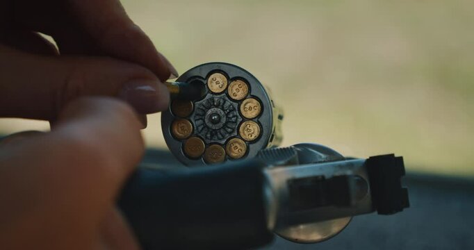 Close-up of revolver cylinder being loaded with ammunition during firearms training
