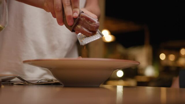 Waiter Grating Bottarga On Top Of The Dish For Elegant Gourmet Dinner 