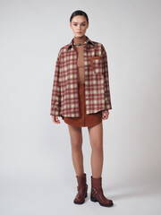 Fashion shooting in studio . Professional model , fashionable clothes and style, new collection. stylish look