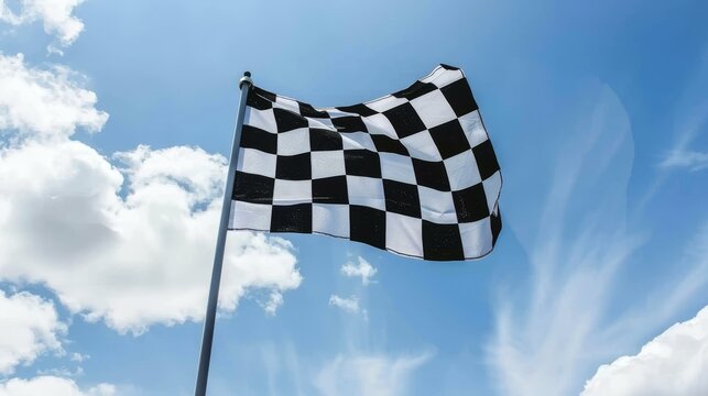 A checkered flag flutters under a clear blue sky, symbolizing victory and the thrill of racing.