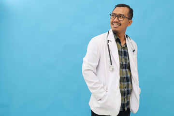 Asian adult male doctor standing facing sideways, wearing doctor's coat, stethoscope around neck,...