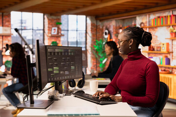Programmer coding advanced AI algorithm in startup workspace, refining machine learning models to...