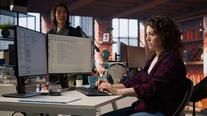 Startup engineer conducting detailed code review to fix bugs, identifying potential performance and...