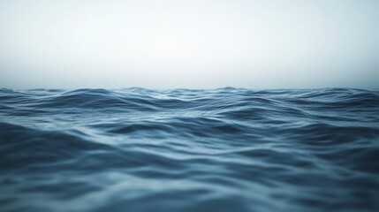 Fototapeta premium Calm ocean waves under a hazy sky.