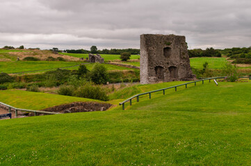 A castle sits in a field of grass
