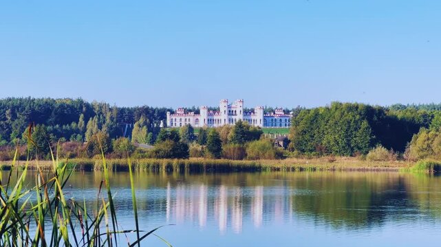 Belarus, Puslovsky Palace, September 5, 2024: Kossovsky Autumn Castle on the shore of Lake Albertino. An old castle in Kosovki in autumn. An architectural monument in the style of English Neo-Gothic.
