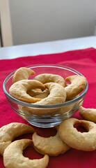 Bowl of homemade crescent cookies on red cloth
