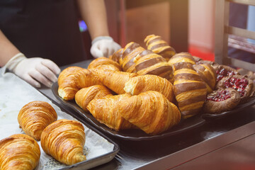 Fresh croissants on counter at bakery