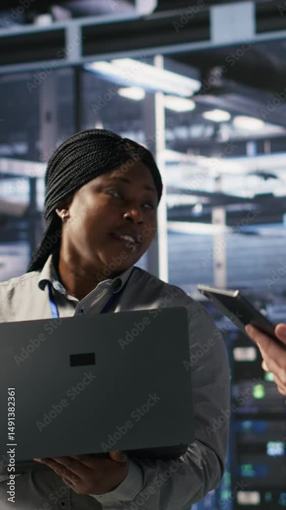 Poster vertical video data scientists working together in server room, reviewing neural network code and ll