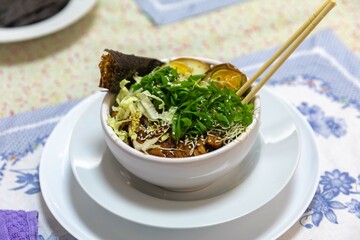 Traditional Japanese ramen or ramen with vegetable broth, grilled pork, oriental noodles and classic Japanese cuisine spices