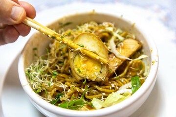 Traditional Japanese ramen or ramen with vegetable broth, grilled pork, oriental noodles and...