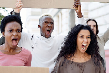 Furious demonstrators making strike against racism, pollution, war. International group of...