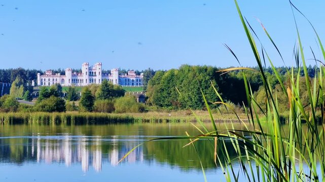 Belarus, Puslovsky Palace, September 5, 2024: Kossovsky Autumn Castle on the shore of Lake Albertino. An old castle in Kosovki in autumn. An architectural monument in the style of English Neo-Gothic.