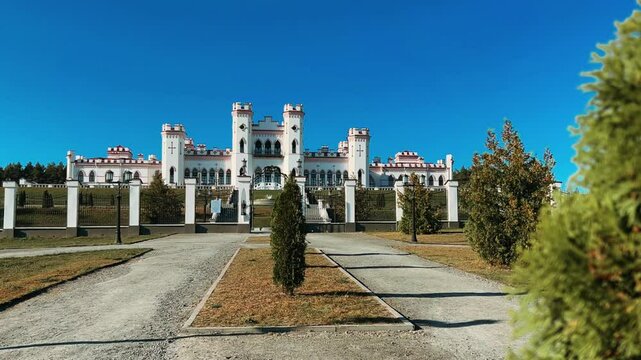 Belarus, Puslovsky Palace, September 5, 2024: Kossovsky Autumn Castle. An old historical castle in Kosovki in sunny autumn weather. An architectural monument in the style of English Neo-Gothic. 4K