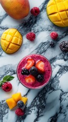 Bright tropical smoothie with fresh fruits garnished on a marble surface