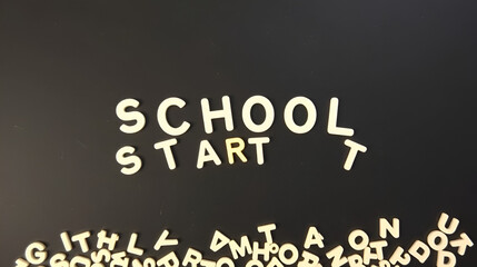 School start message with scattered letters on black background
