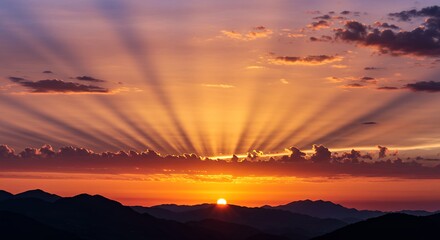 Fototapeta premium Sunset Over Mountains with Dramatic Light Rays