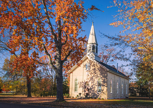 small church in the town among the autumn foliage