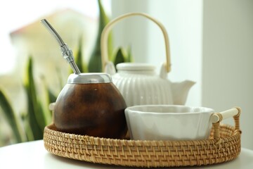 Traditional yerba mate tea on white table indoors, closeup